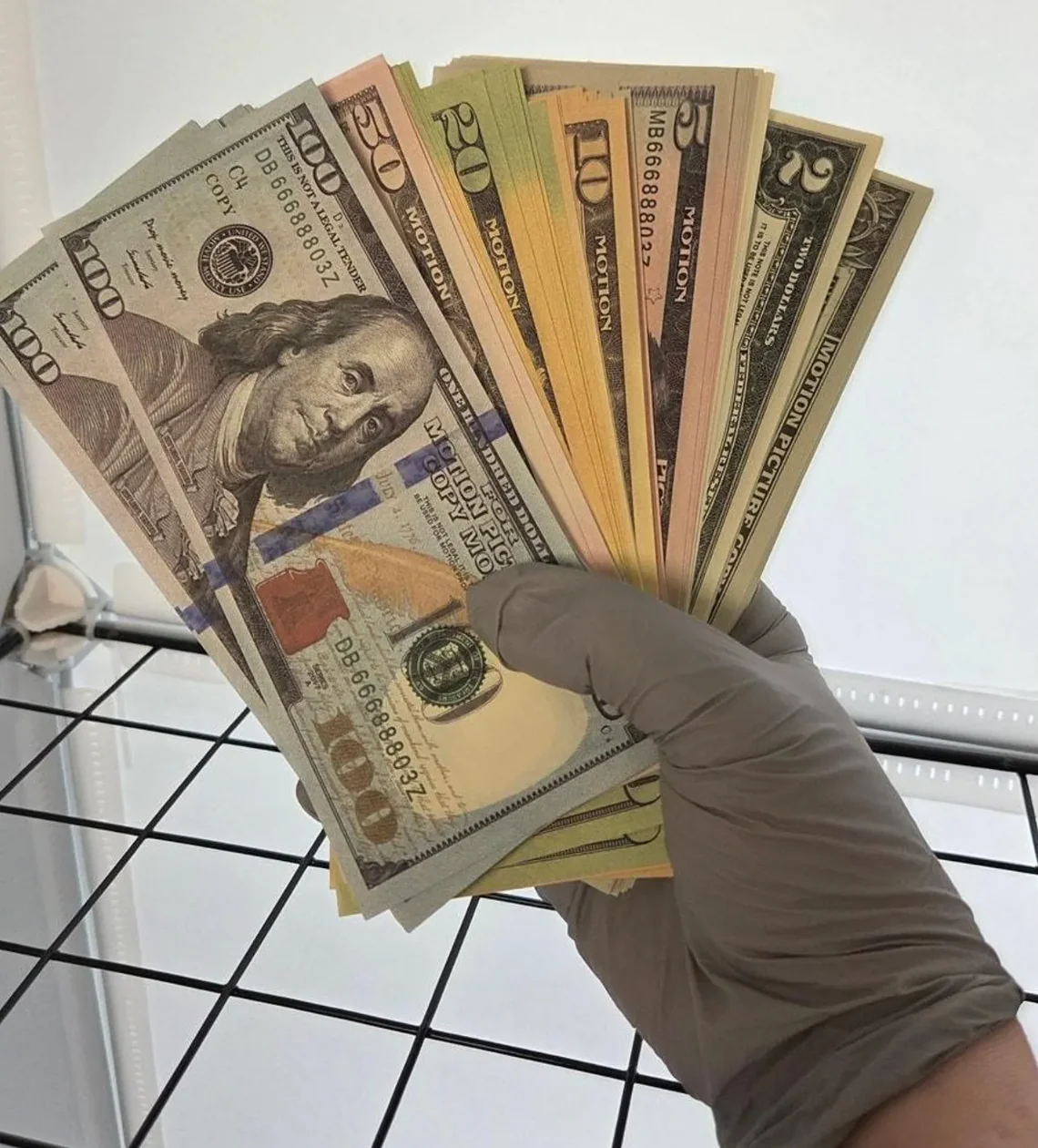 Fanned prop currency notes marked for motion picture use